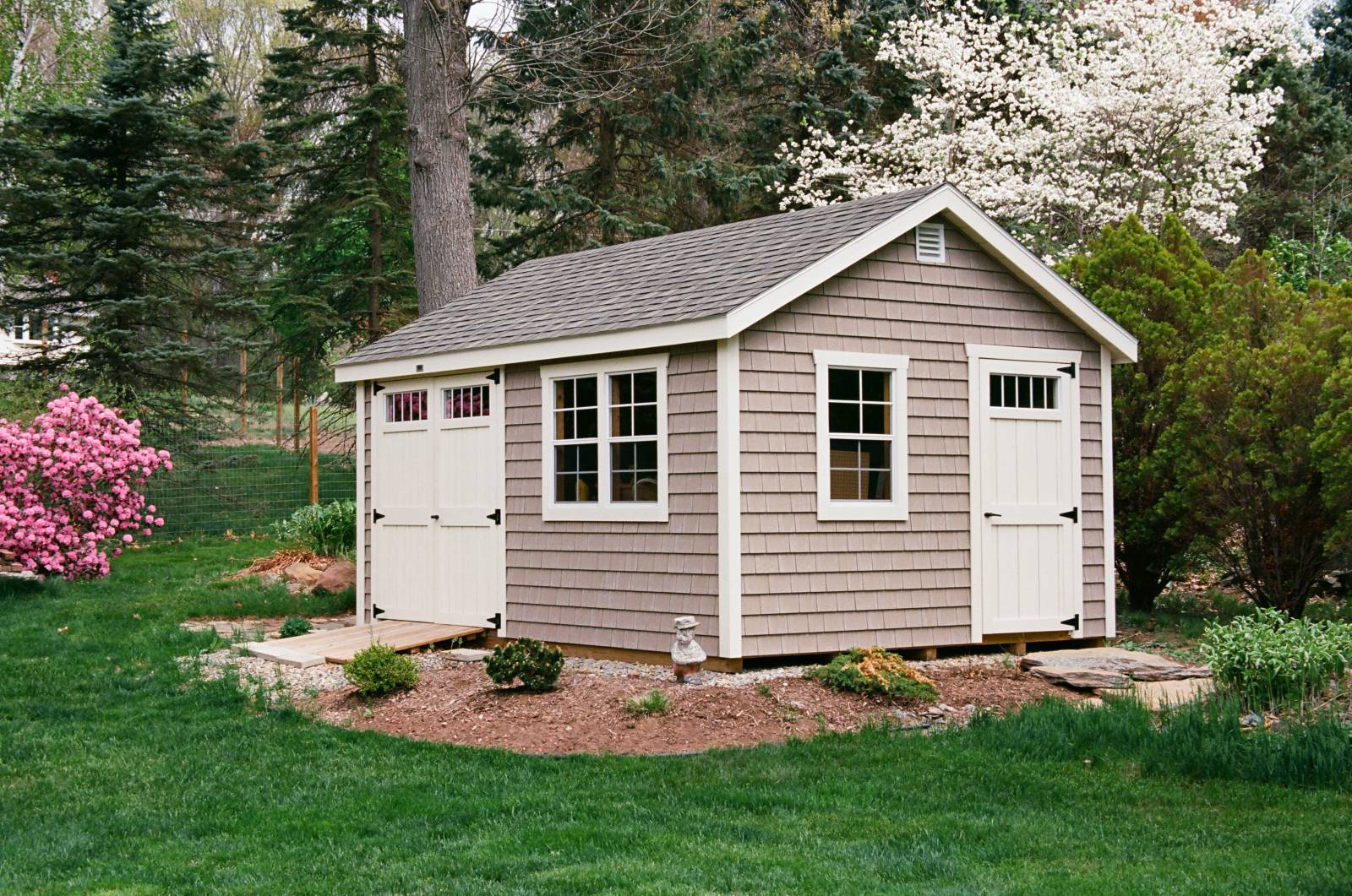 Angle Showing 3' Single Door with Transom Window • Upgraded MiraTEC Trim • 6"³ Overhangs • A Beautiful Garden Shed!