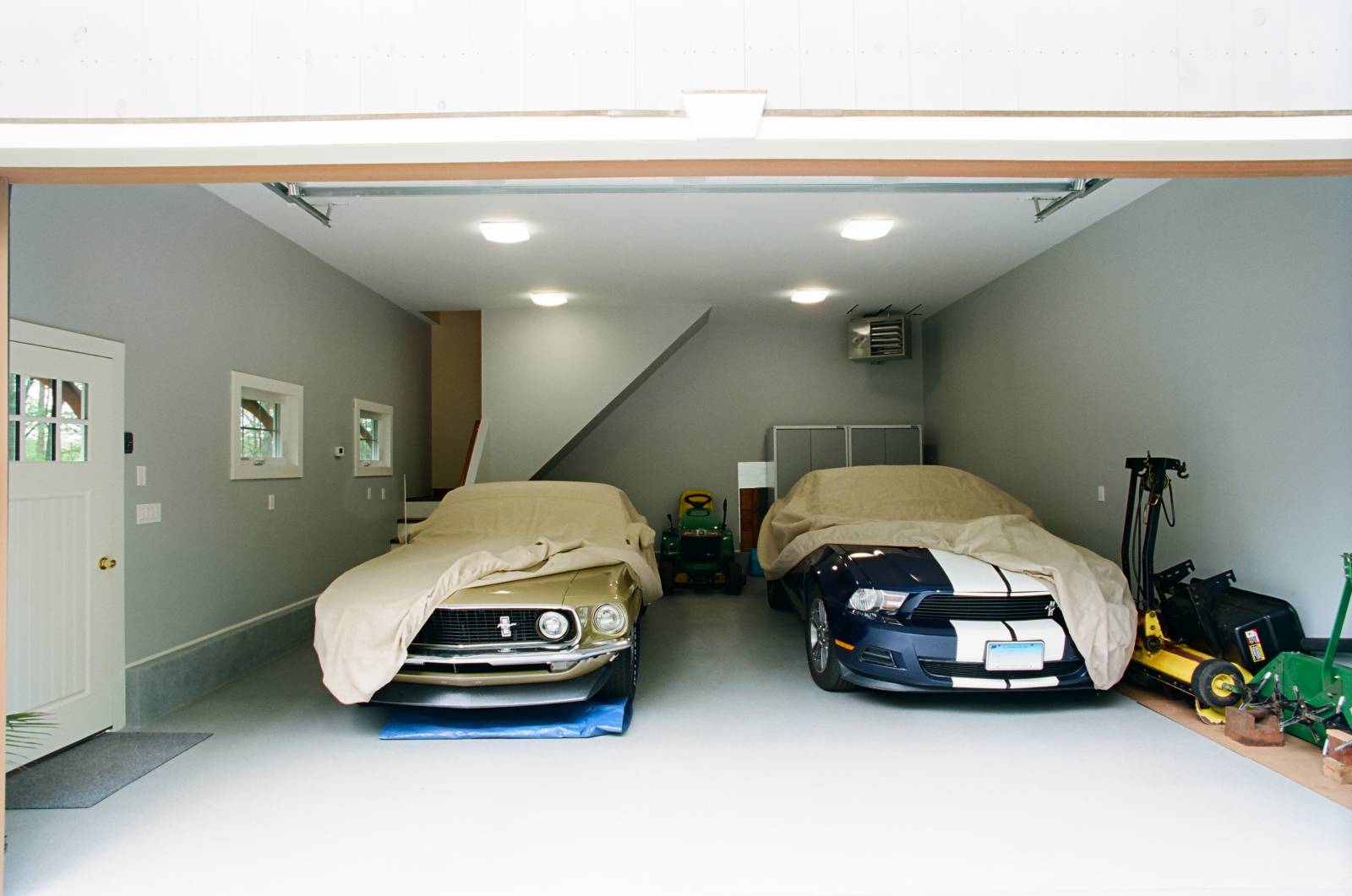 A pair of Mustangs in the finished 2-car garage