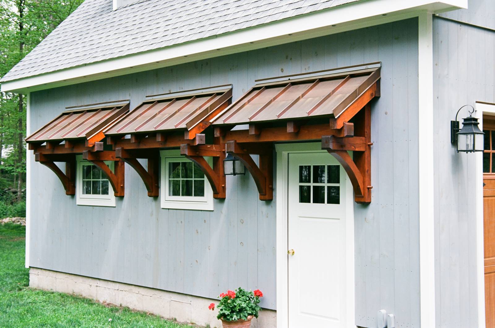Timber frame eyebrow roofs with copper standing seam