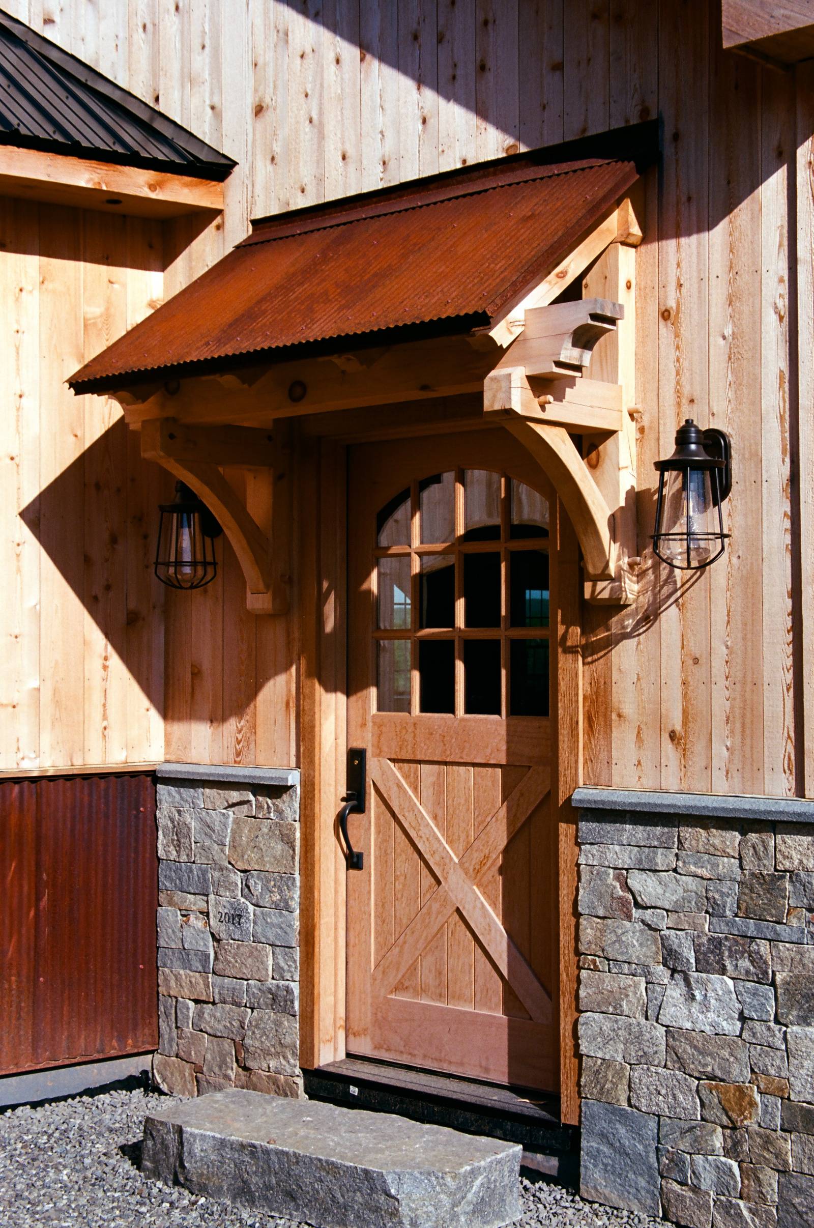 Timber Frame Eyebrow Roof over Entry Door