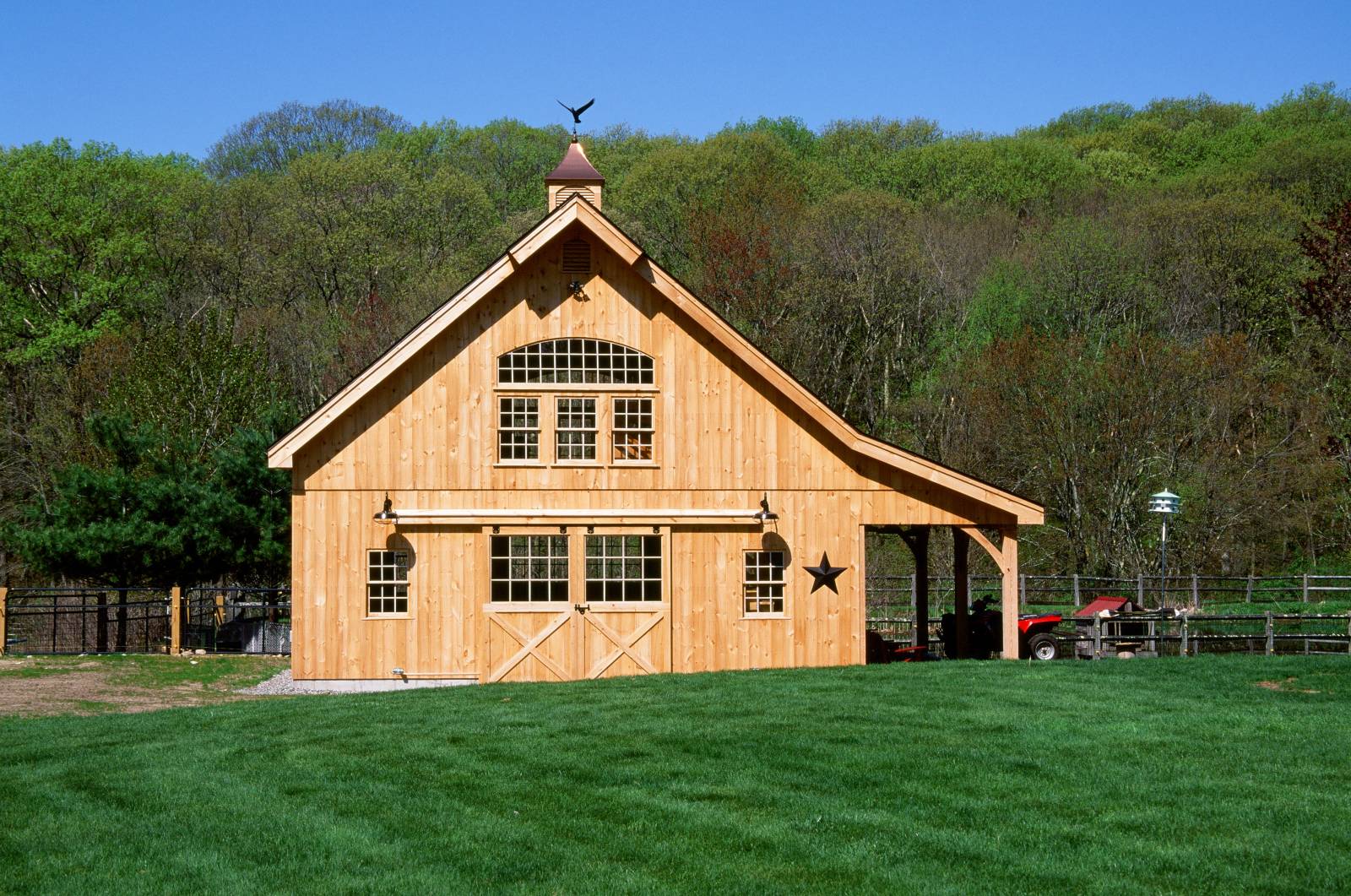 Front view of the barn with 8' x 8' pine split sliding barn doors with half glass