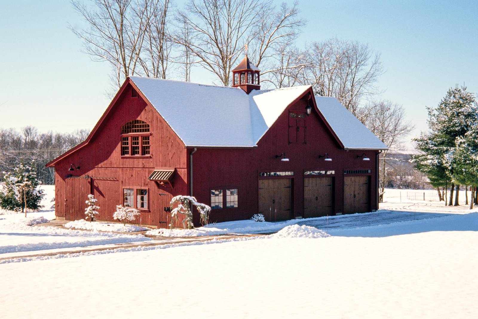 3-bay post & beam 2-story barn garage with reverse gable dormer & lean-to covered in snow