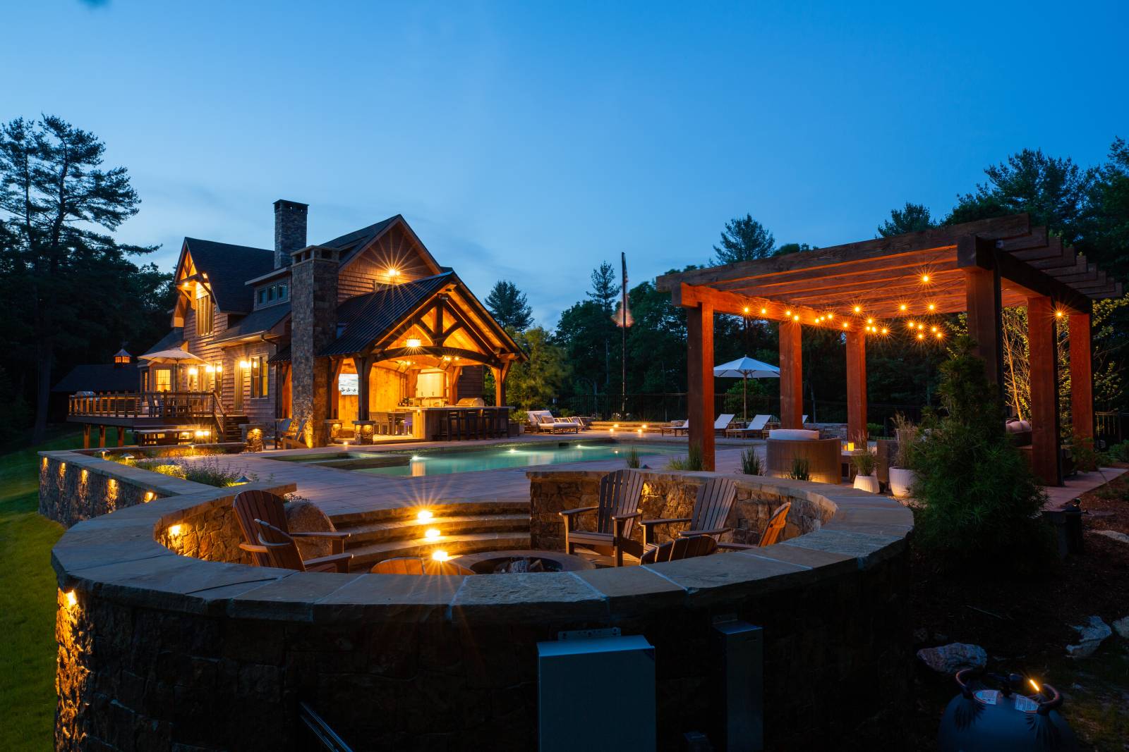 The Full Poolscape • Firepit in Front, Pergola to the Right, Custom Pavilion in Back Left