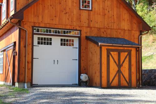 Rear of the garage with attached wood shed