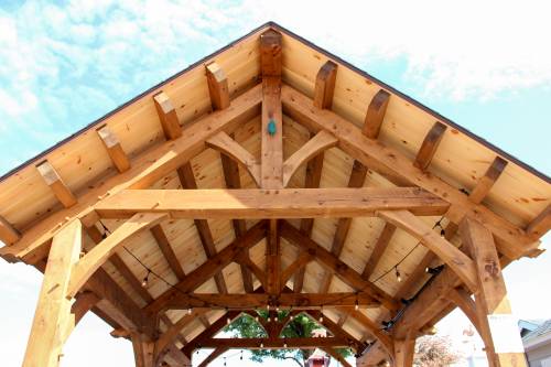 Timeless design: traditional common purlins and king post trusses with straight bottom chords and arched braces