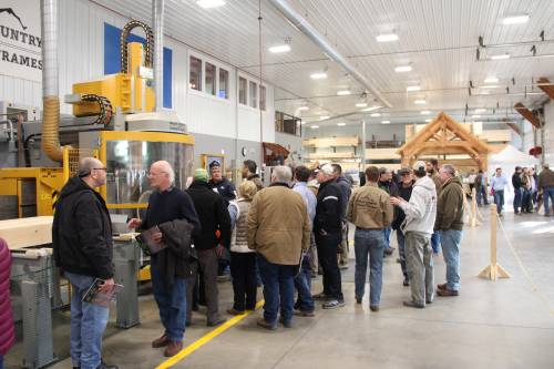 A crowd gathers around the CNC machine