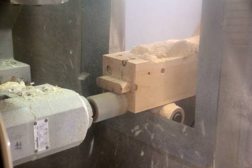 CNC machine crafting timber sill joinery on a Carriage Barn post