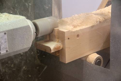 CNC machine crafting timber sill joinery on a Carriage Barn post