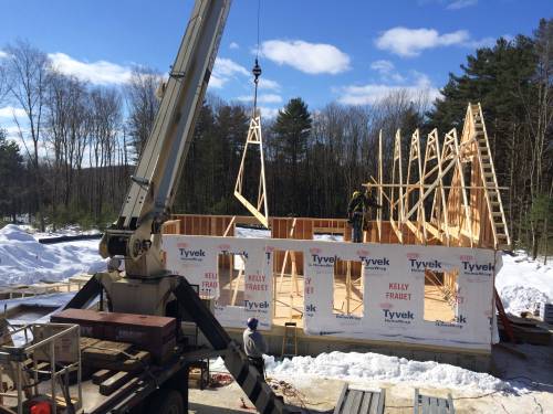 Crane lifting the roof trusses into place