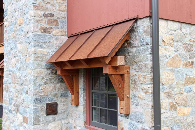 Timber Frame Eyebrow Roof with Standing Seam Rusty Metal Roof