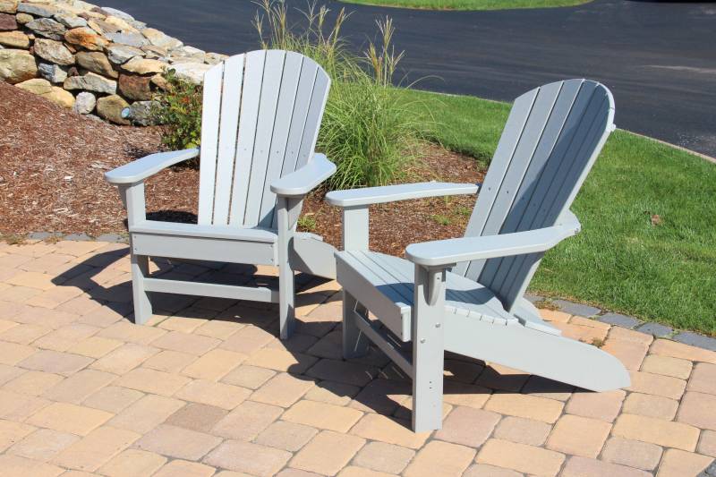 Two gray-blue poly Adirondack chairs