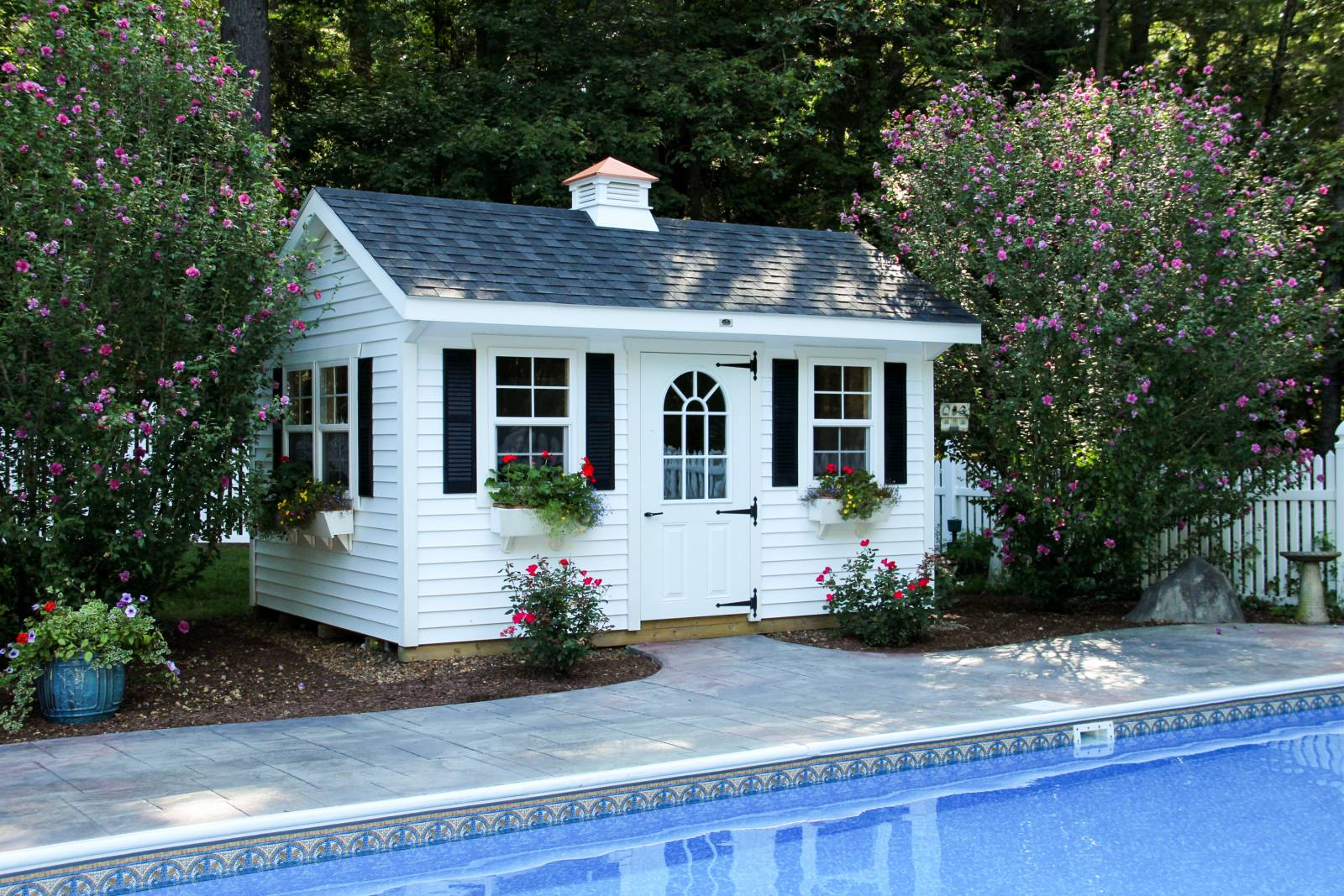 Pool house with black louvered shutters • half glass door • saltbox-style roofline • 18" front overhang
