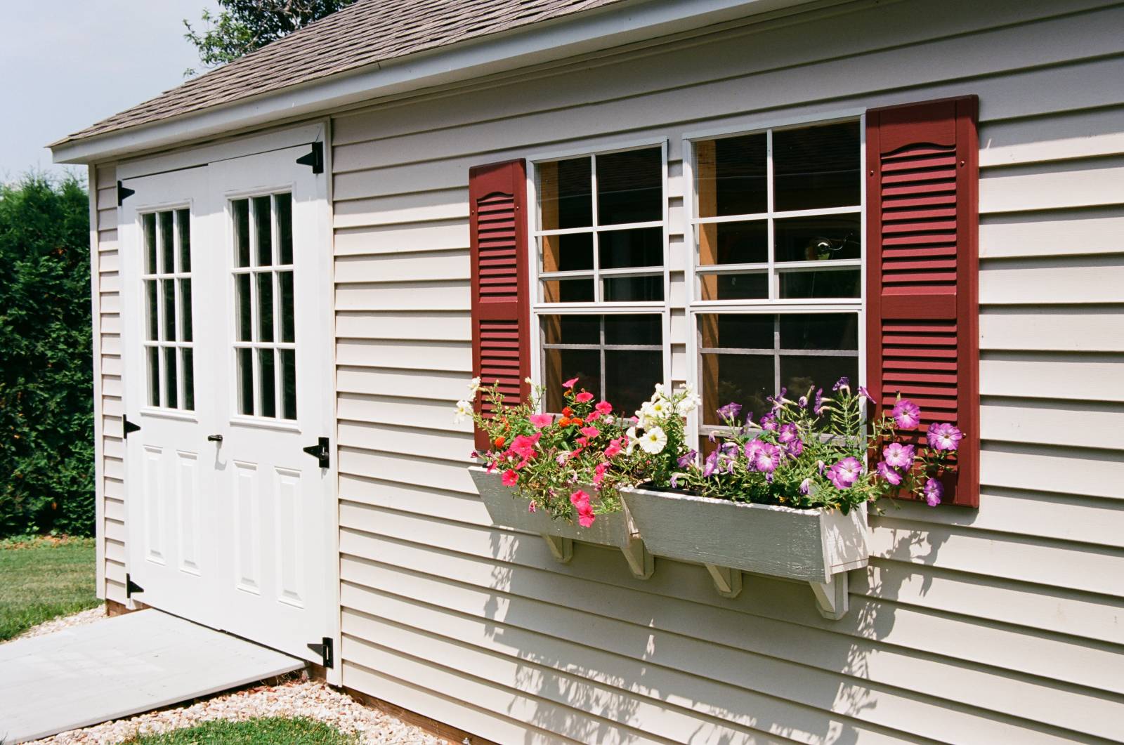 Vinyl siding • shutters • flower boxes • double door with half glass