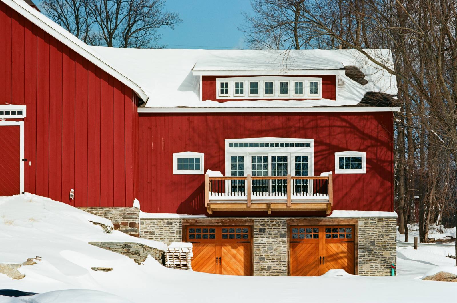 Front view showing cantilever deck • custom garage doors • transom dormer