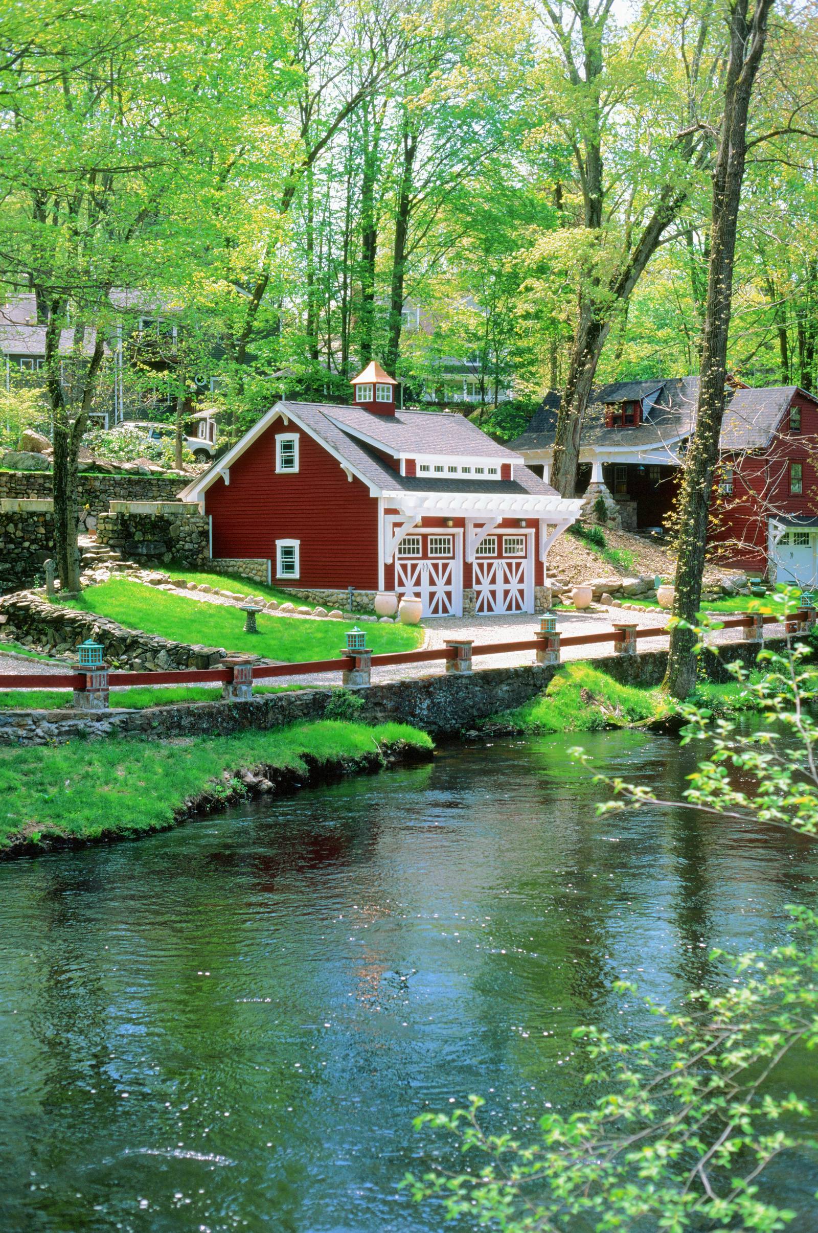 A storybook setting for this custom garage along a riverbank in Fairfield CT