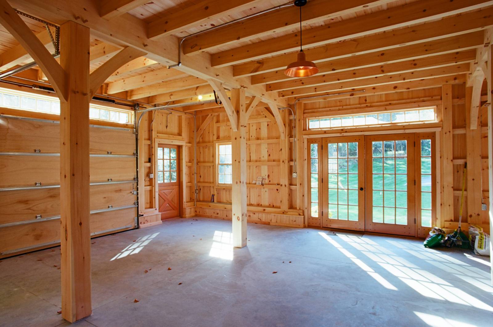 First floor of the bank barn with light streaming in and exposed beams