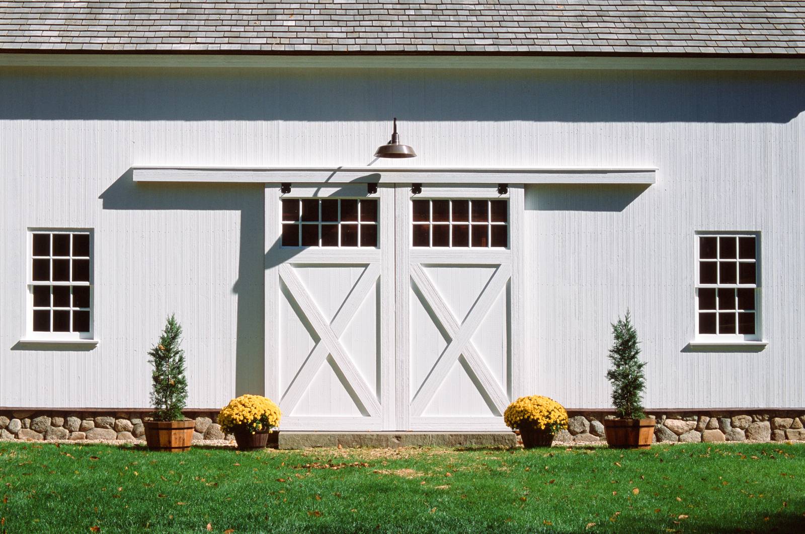 Split sliding barn doors closed (also notice the stone capped foundation)