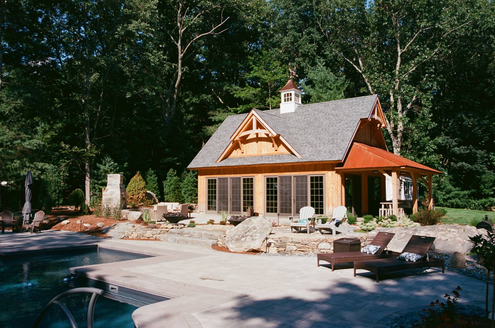 Timber Frame Accents on the Pool House • Custom Hardscape Surrounding the Pool