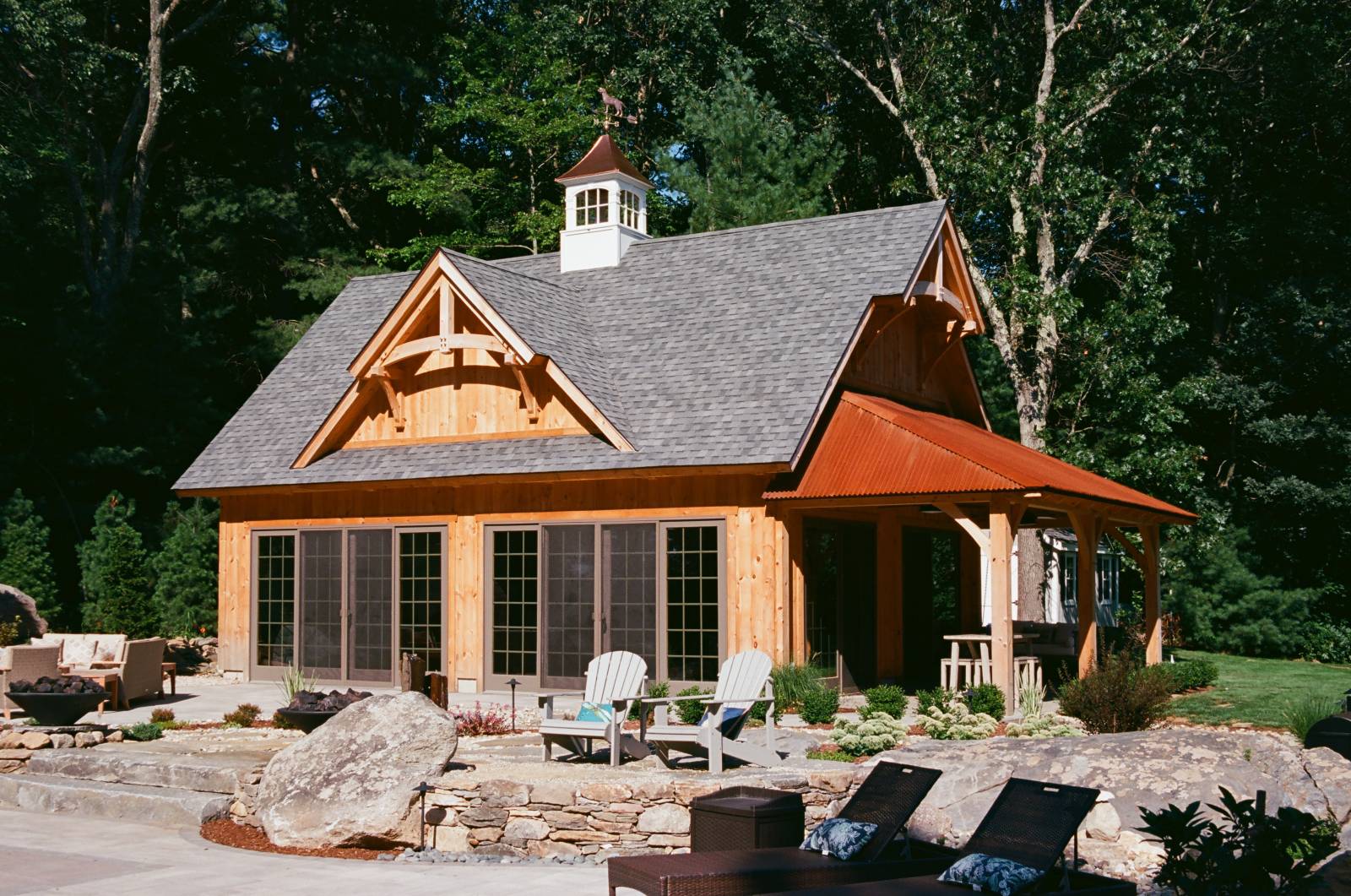 Details of the Pool House: Gable Dormer with Timber Frame Accent • Turkey Tail Peaks with Timber Accents • 10' x 24' Open Hip Roof Lean-To Overhang • Full View Glass Sliding Doors