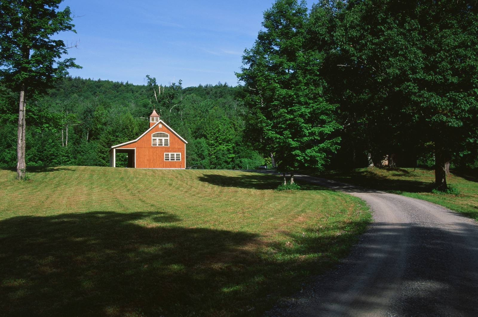 Down a sunny dirt road in New Hampshire is this beautiful Carriage Barn