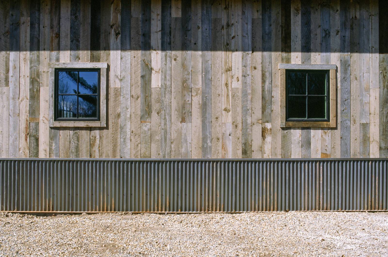 Trestlewood Barn Board Siding with Andersen 400 Series Black Windows & Bridger Steel Corrugated Rusty Metal Wainscot