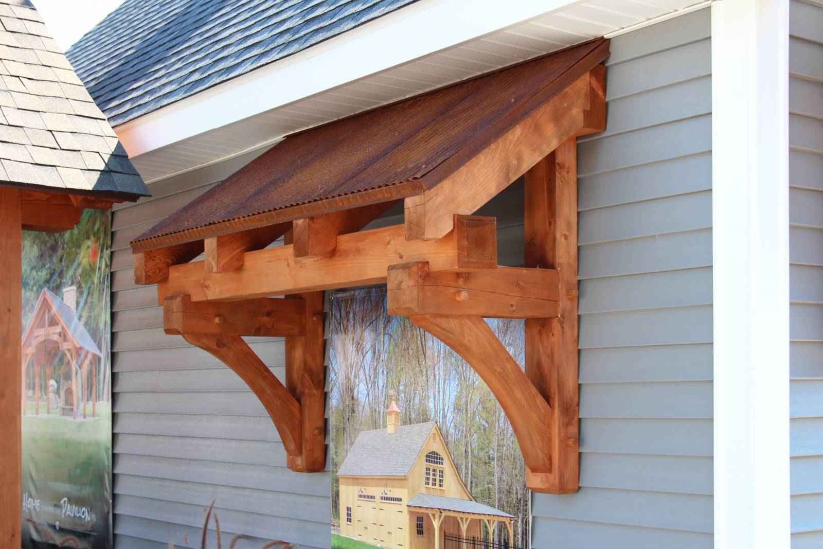 Timber Frame Eyebrow Roof over Entry Door + Rustic Metal Roofing