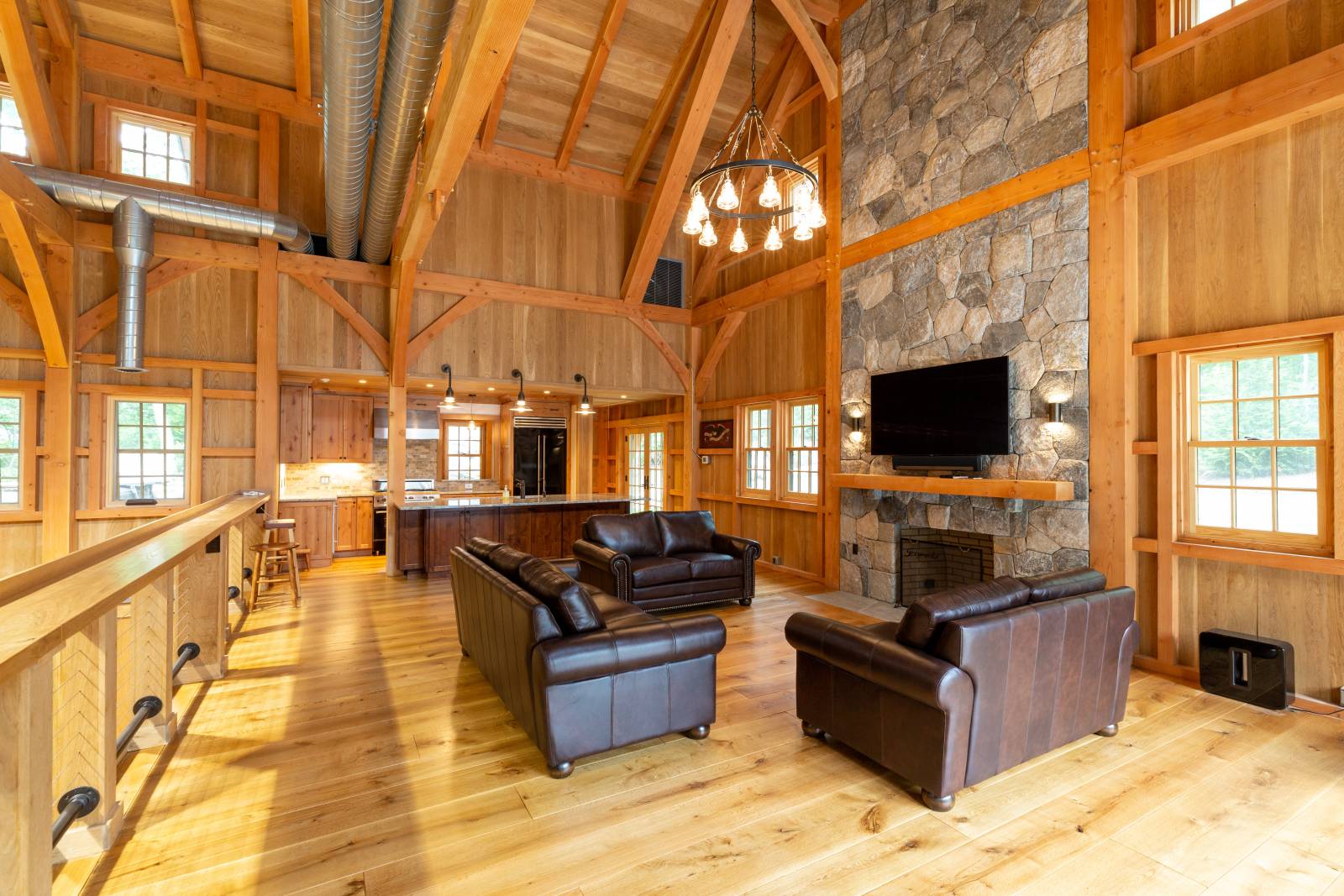 Living Room in the Custom Timber Frame Barn • Stone Fireplace
