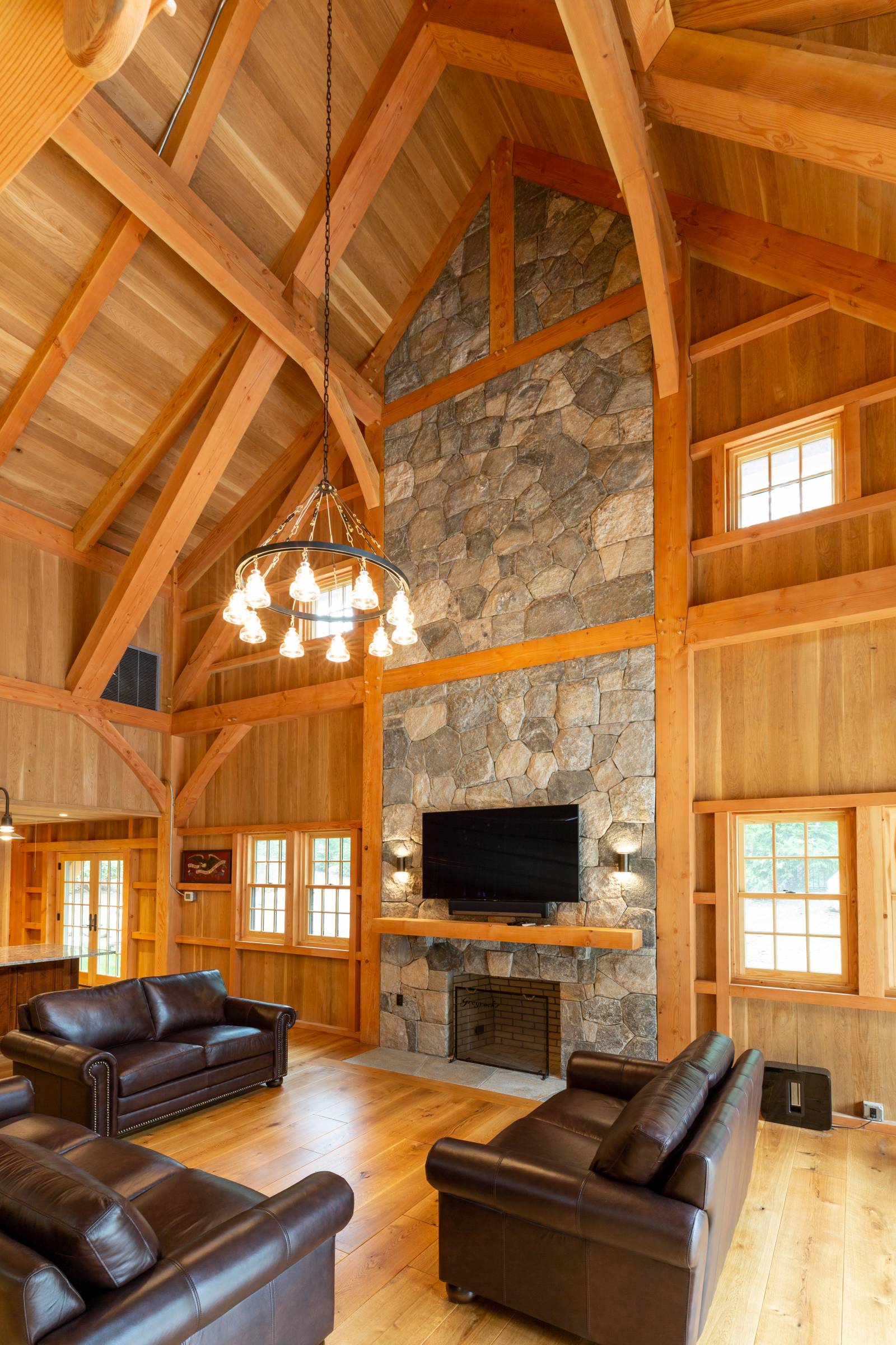 Floor-to-Ceiling Stone Fireplace set into the Timber Frame