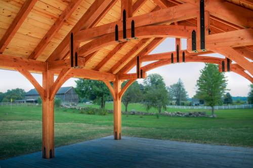 View from under the outdoor pavilion showing hammer beam roof design