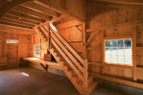 Heavy timber stairway over timber frame workbench
