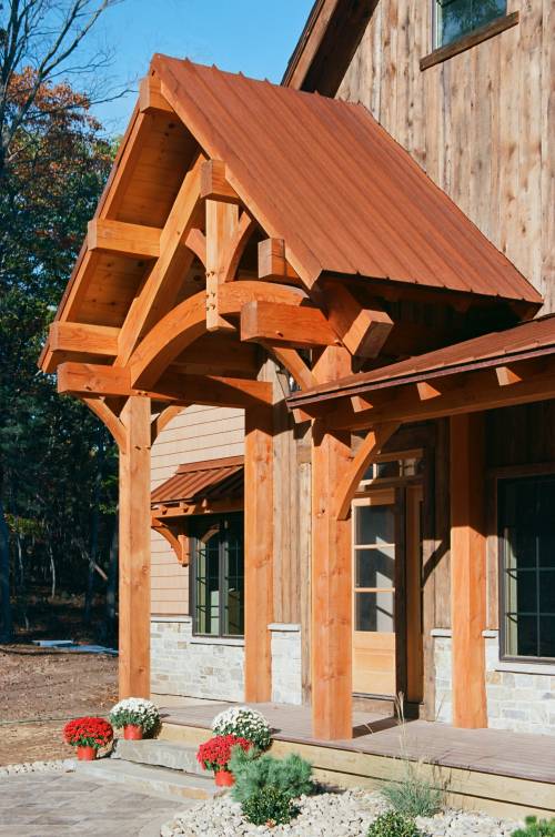 Timber frame portico with rusty metal roof