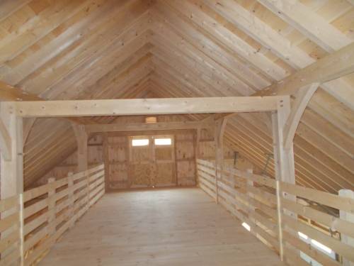 Spacious hay storage loft in post and beam horse barn