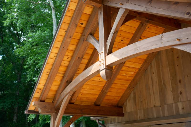 Detail: Curved Timbers in the Overhang • Arched Bottom Chord •Â King Post Truss