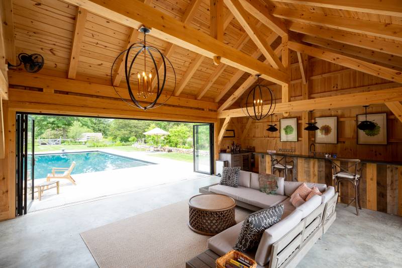 Expansive Timber Frame Pool House Interior with Bar & Seating Area • Exposed Timbers • Modern Design