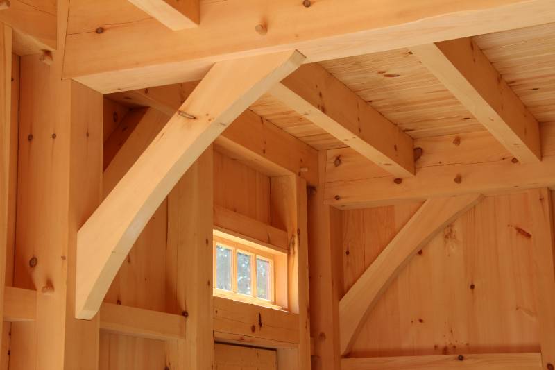 Timber framing above the entry door (notice the arched braces)