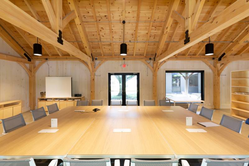 At the Conference Table • Intricate Timber Frame Structure Overhead