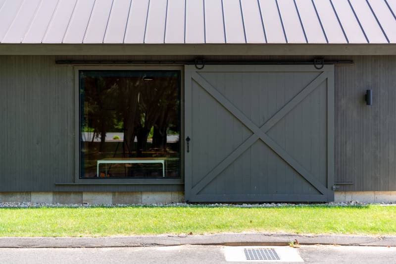 Sliding Barn Door Revealing Full Glass Window • Authentic Horseshoe Track
