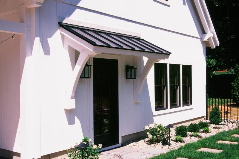9' Timber Frame Eyebrow Roof with Standing Seam Metal Roof (above entry door)