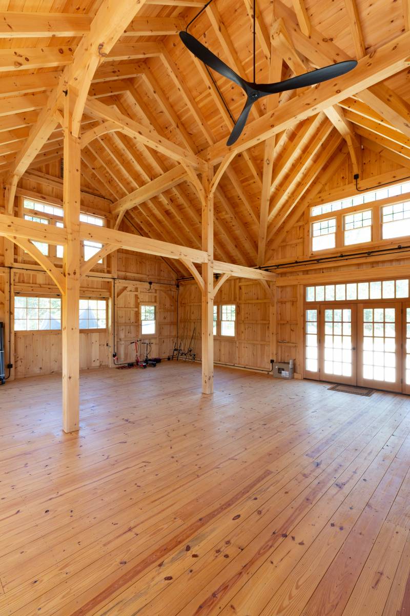 Floor-to-ceiling posts • cathedral ceilings • southern yellow pine wood floor • large open barn space for events