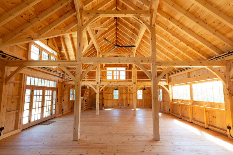 Wide shot showing the timber frame structure inside the bank barn on the first floor