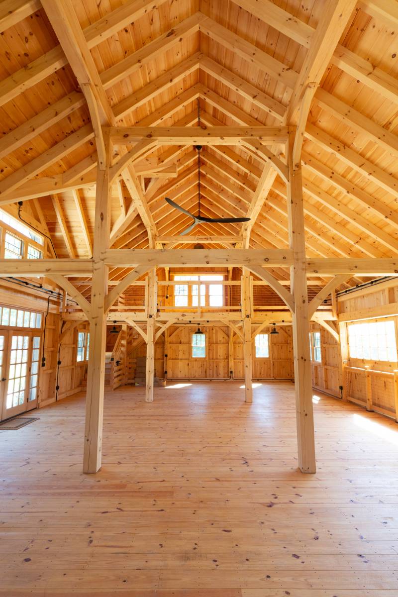 Large open barn space for events with floor-to-ceiling posts & exposed timbers