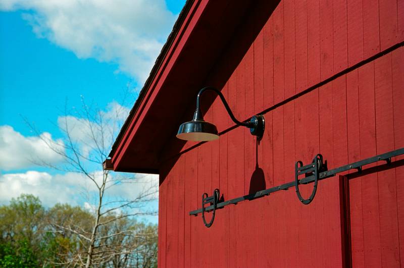 Gooseneck barn light and horseshoe track hardware on sliding barn door