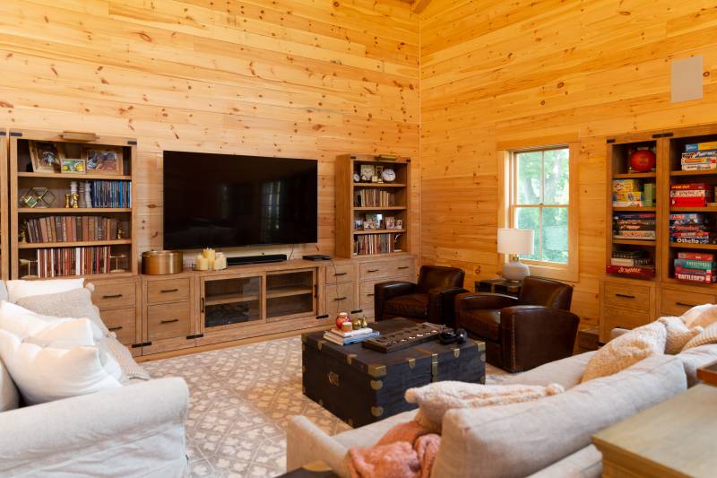 The living room zone of the family barn with home theater • books • photo albums • games • comfy couches