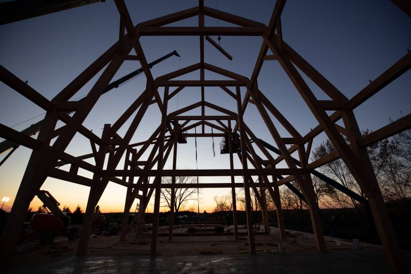 Gambrel-style timber bents in the Iowa sunset