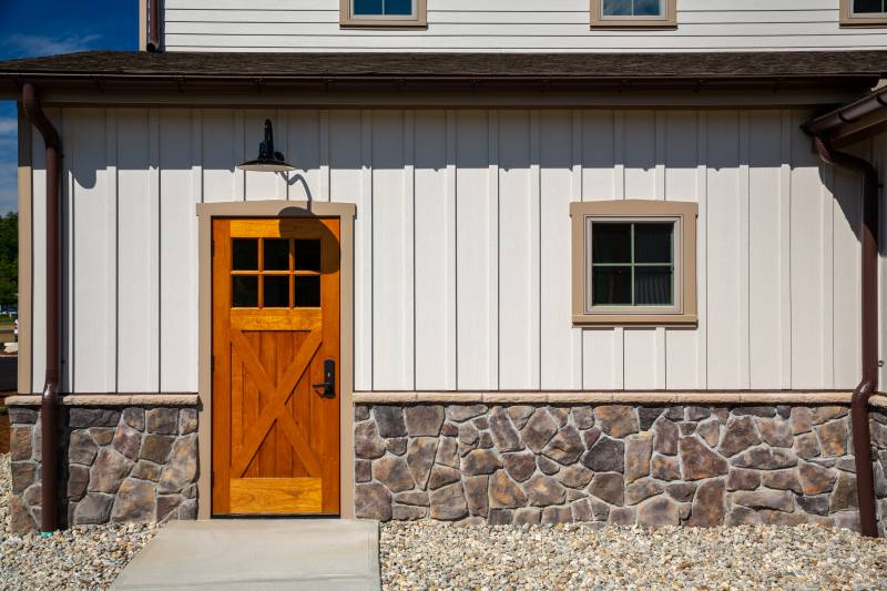 Detail: Wood Entry Door with Crossbucks & Glass • Board & Batten Siding • Square Barn Window