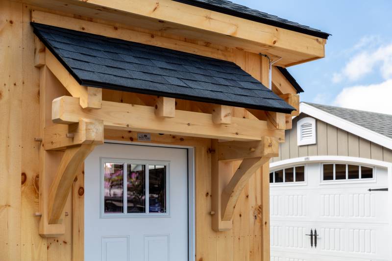 Timber Frame Eyebrow Roof over Entry Door