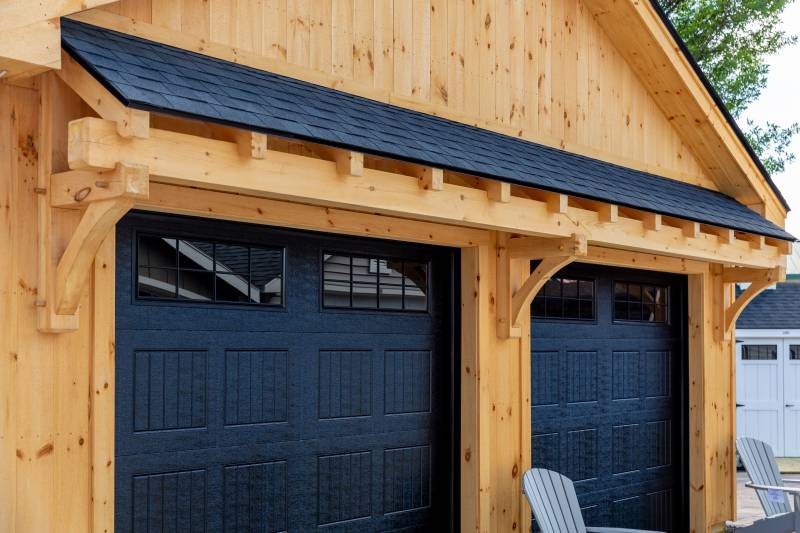 Timber Frame Eyebrow Roof over Garage Doors