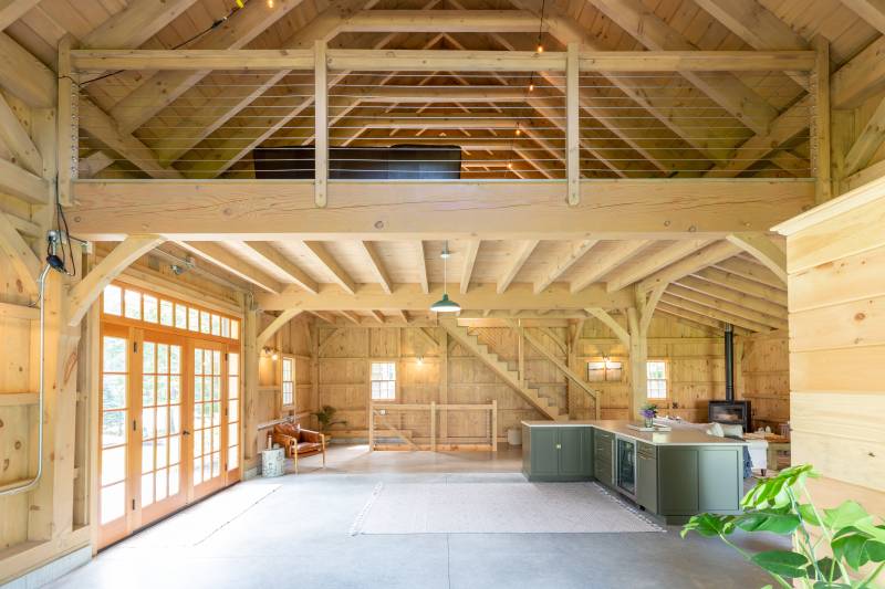 View inside the Lenox Carriage Barn showing the 22' x 24' upstairs loft with solid sawn Douglas Fir clear span beams and wire railing