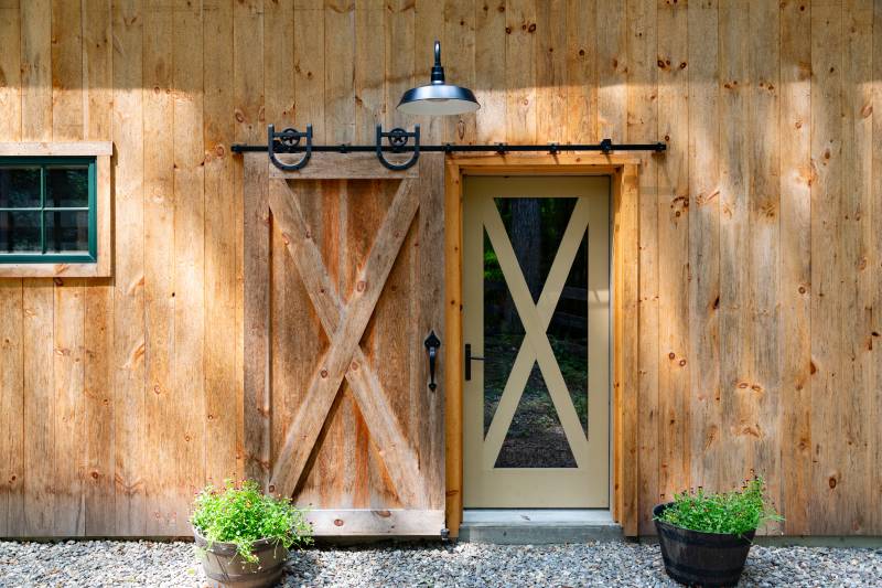 Sliding Barn Door Reveals 3' x 7' Entry Door